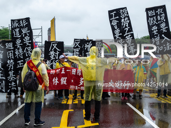 Protesters posing with banners and flags calling for more holidays, paid leave, more labour rights protections. During 2019 Labor Day March...