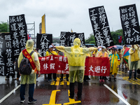 Protesters posing with banners and flags calling for more holidays, paid leave, more labour rights protections. During 2019 Labor Day March...