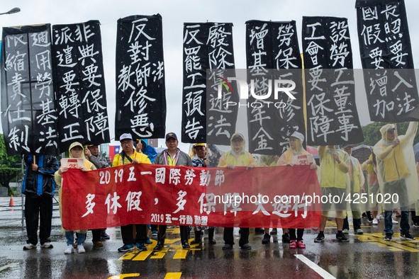 Protesters posing with banners and flags calling for more holidays, paid leave, more labour rights protections. During 2019 Labor Day March...