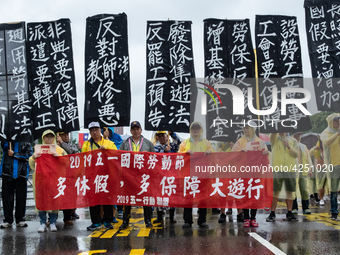 Protesters posing with banners and flags calling for more holidays, paid leave, more labour rights protections. During 2019 Labor Day March...