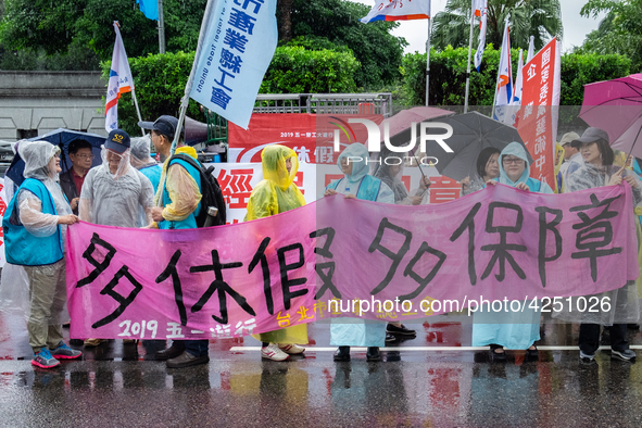 Protesters posing with banners and flags calling for more holidays, paid leave, more labour rights protections. During 2019 Labor Day March...