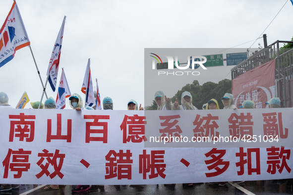 Protesters marching with banners and flags calling for more holidays, paid leave, more labour rights protections. During 2019 Labor Day Marc...