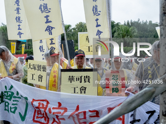 Protesters marching with banners and flags calling for more holidays, paid leave, more labour rights protections. During 2019 Labor Day Marc...