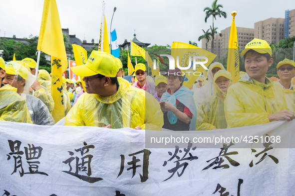 Protesters marching with banners and flags calling for more holidays, paid leave, more labour rights protections. During 2019 Labor Day Marc...