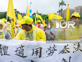 Protesters marching with banners and flags calling for more holidays, paid leave, more labour rights protections. During 2019 Labor Day Marc...