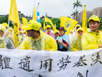 Protesters marching with banners and flags calling for more holidays, paid leave, more labour rights protections. During 2019 Labor Day Marc...