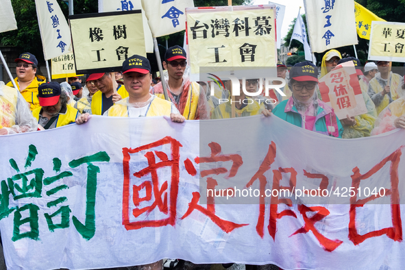 Protesters marching with banners and flags calling for more holidays, paid leave, more labour rights protections. During 2019 Labor Day Marc...