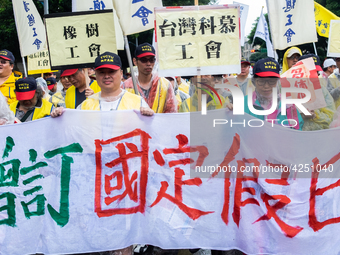 Protesters marching with banners and flags calling for more holidays, paid leave, more labour rights protections. During 2019 Labor Day Marc...