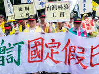 Protesters marching with banners and flags calling for more holidays, paid leave, more labour rights protections. During 2019 Labor Day Marc...