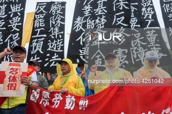 Protesters with banners and flags calling for more holidays, paid leave, more labour rights protections. During 2019 Labor Day March 6,000 w...