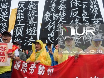 Protesters with banners and flags calling for more holidays, paid leave, more labour rights protections. During 2019 Labor Day March 6,000 w...