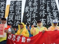 Protesters with banners and flags calling for more holidays, paid leave, more labour rights protections. During 2019 Labor Day March 6,000 w...