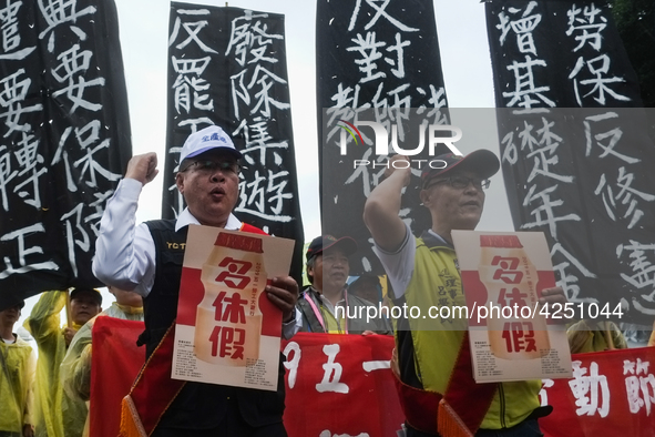 Protesters with banners and flags calling for more holidays, paid leave, more labour rights protections. During 2019 Labor Day March 6,000 w...