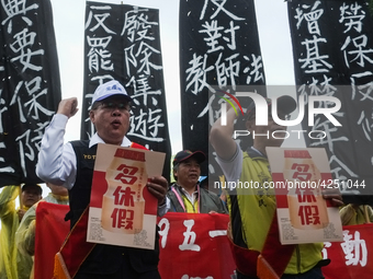 Protesters with banners and flags calling for more holidays, paid leave, more labour rights protections. During 2019 Labor Day March 6,000 w...