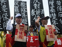 Protesters with banners and flags calling for more holidays, paid leave, more labour rights protections. During 2019 Labor Day March 6,000 w...