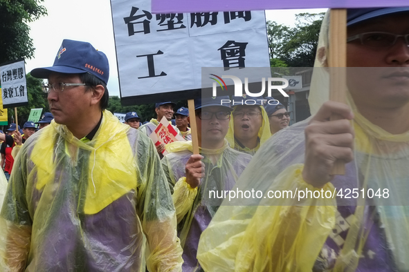 Protesters marching with banners and flags calling for more holidays, paid leave, more labour rights protections. During 2019 Labor Day Marc...