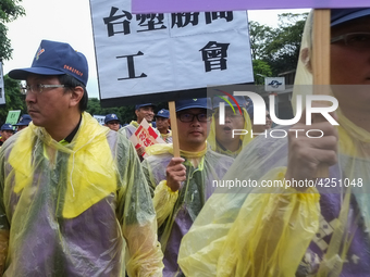 Protesters marching with banners and flags calling for more holidays, paid leave, more labour rights protections. During 2019 Labor Day Marc...