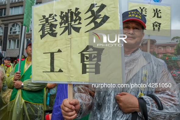 A Protester marching with a banner calling for more holidays, paid leave, more labour rights protections. During 2019 Labor Day March 6,000...