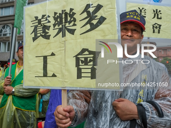 A Protester marching with a banner calling for more holidays, paid leave, more labour rights protections. During 2019 Labor Day March 6,000...