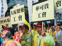 Protesters marching with banners calling for more holidays, paid leave, more labour rights protections. During 2019 Labor Day March 6,000 wo...