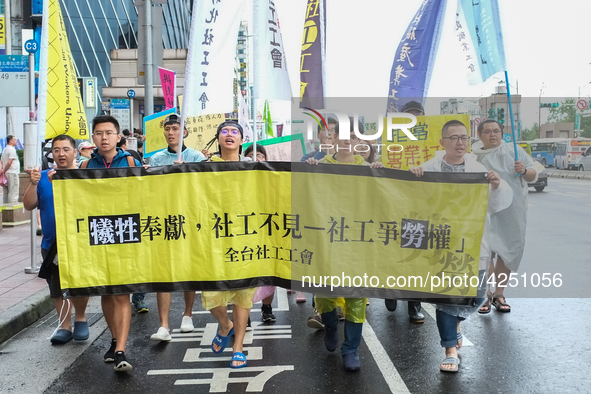 Protesters marching with banners and flags calling for more holidays, paid leave, more labour rights protections. During 2019 Labor Day Marc...