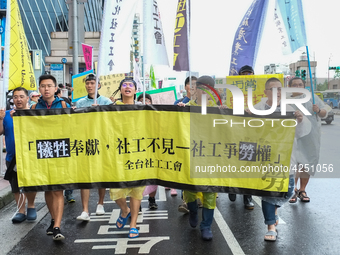 Protesters marching with banners and flags calling for more holidays, paid leave, more labour rights protections. During 2019 Labor Day Marc...