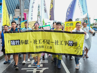 Protesters marching with banners and flags calling for more holidays, paid leave, more labour rights protections. During 2019 Labor Day Marc...