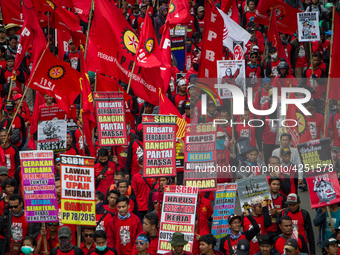 Indonesian workers take part in a May Day rally in Jakarta on May 1, 2019.  Thousands of Indonesian workers are urging the government to rai...