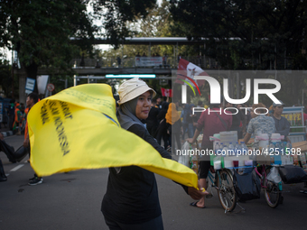 Indonesian worker pose during a May Day rally in Jakarta on May 1, 2019.  Thousands of Indonesian workers are urging the government to raise...