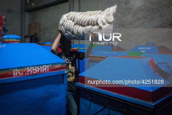 A man arranges dried kerupuk or crackers after they fry it at a kerupuk factory in Depok, Indonesia, 01 May 2019. Despite the government's d...