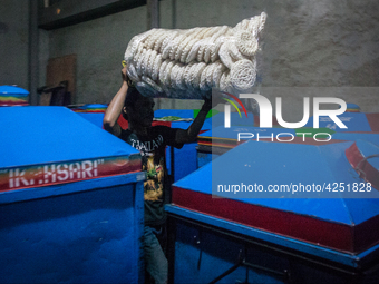 A man arranges dried kerupuk or crackers after they fry it at a kerupuk factory in Depok, Indonesia, 01 May 2019. Despite the government's d...