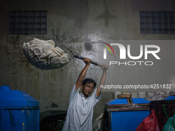 A man carries a basket full with kerupuk or crackers after frying them at a kerupuk factory in Depok, Indonesia, 01 May, 2019. Despite the g...