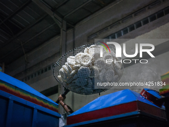 A man carries a basket full with kerupuk or crackers after frying them at a kerupuk factory in Depok, Indonesia, 01 May, 2019. Despite the g...