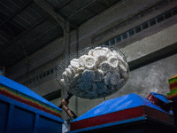 A man carries a basket full with kerupuk or crackers after frying them at a kerupuk factory in Depok, Indonesia, 01 May, 2019. Despite the g...