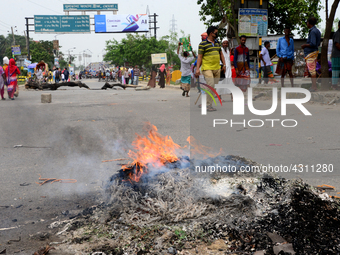 Bangladeshi Jute mill workers stage a road block demonstration to demanding arrears and fair wages at Demra in Dhaka, Bangladesh, on May 11,...