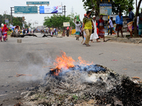 Bangladeshi Jute mill workers stage a road block demonstration to demanding arrears and fair wages at Demra in Dhaka, Bangladesh, on May 11,...