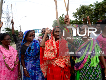 Bangladeshi Jute mill workers stage a road block demonstration to demanding arrears and fair wages at Demra in Dhaka, Bangladesh, on May 11,...