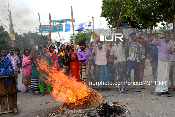 Bangladeshi Jute mill workers stage a road block demonstration to demanding arrears and fair wages at Demra in Dhaka, Bangladesh, on May 11,...