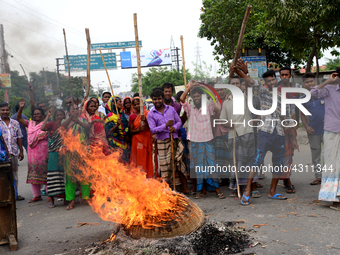 Bangladeshi Jute mill workers stage a road block demonstration to demanding arrears and fair wages at Demra in Dhaka, Bangladesh, on May 11,...