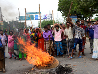 Bangladeshi Jute mill workers stage a road block demonstration to demanding arrears and fair wages at Demra in Dhaka, Bangladesh, on May 11,...