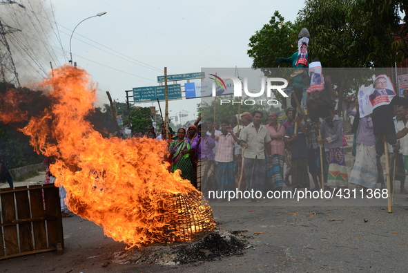 Bangladeshi Jute mill workers stage a road block demonstration to demanding arrears and fair wages at Demra in Dhaka, Bangladesh, on May 11,...