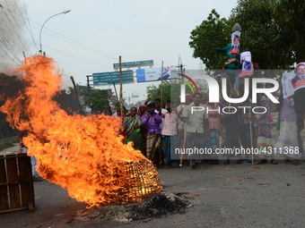 Bangladeshi Jute mill workers stage a road block demonstration to demanding arrears and fair wages at Demra in Dhaka, Bangladesh, on May 11,...