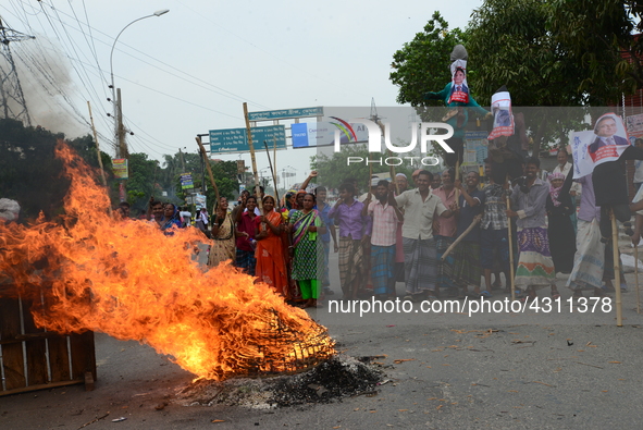 Bangladeshi Jute mill workers stage a road block demonstration to demanding arrears and fair wages at Demra in Dhaka, Bangladesh, on May 11,...