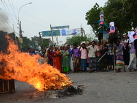 Bangladeshi Jute mill workers stage a road block demonstration to demanding arrears and fair wages at Demra in Dhaka, Bangladesh, on May 11,...