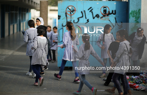 Palestinian students walk on their way to school to attend their end-of-year exams in Gaza City on May 23, 2019. 