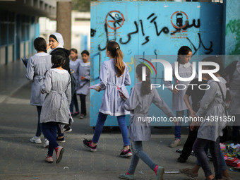 Palestinian students walk on their way to school to attend their end-of-year exams in Gaza City on May 23, 2019. (