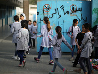 Palestinian students walk on their way to school to attend their end-of-year exams in Gaza City on May 23, 2019. (