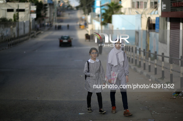 Palestinian students walk on their way to school to attend their end-of-year exams in Gaza City on May 23, 2019. 