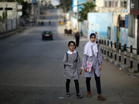 Palestinian students walk on their way to school to attend their end-of-year exams in Gaza City on May 23, 2019. (