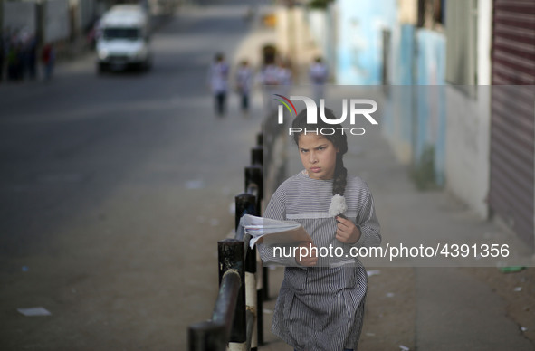 Palestinian students walk on their way to school to attend their end-of-year exams in Gaza City on May 23, 2019. 